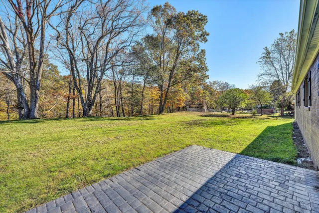 a backyard of a house with yard and outdoor seating