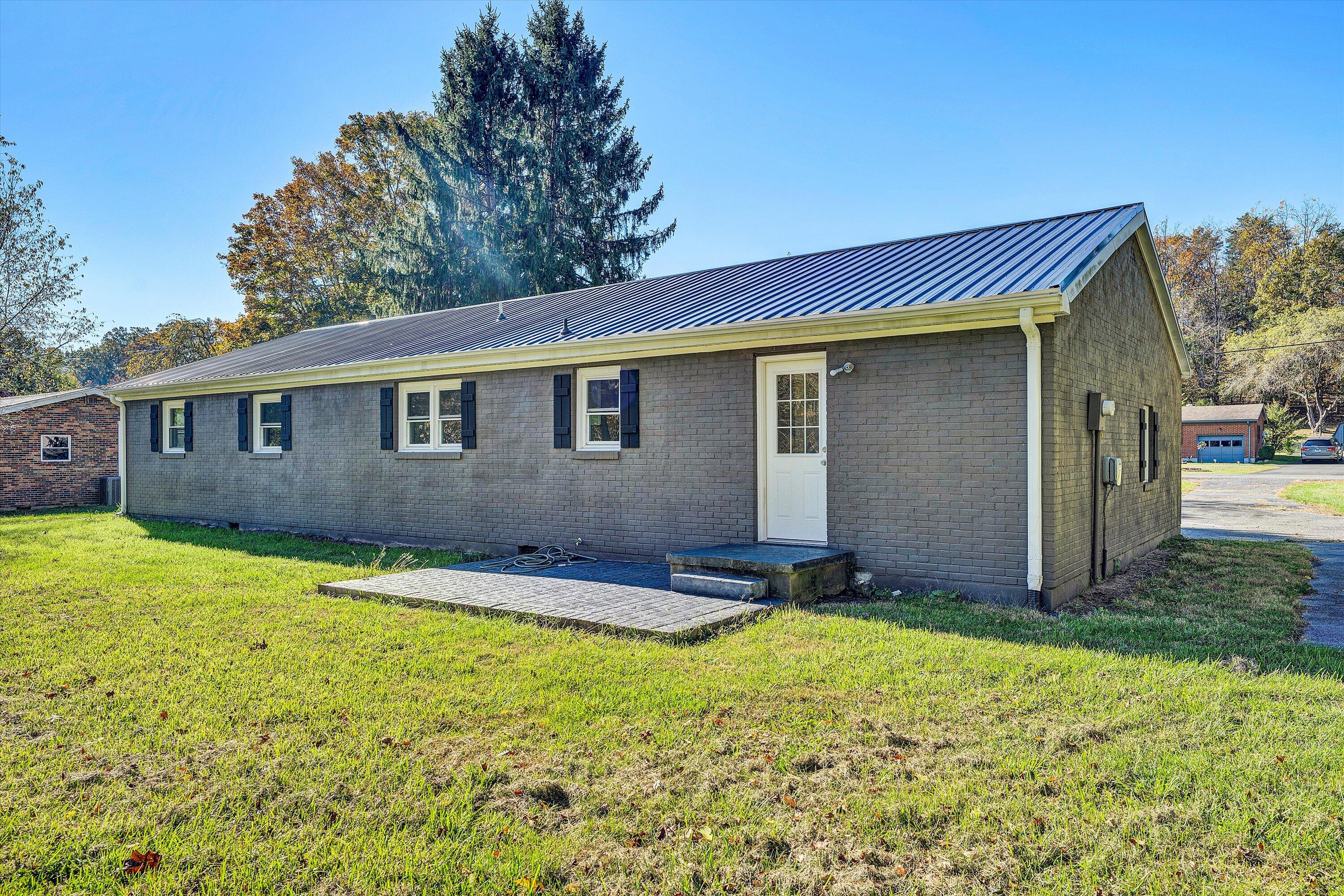 304 Broken Arrow Lane Covington, VA 24426 - Photo 39 of 46 a backyard of a house with yard and outdoor seating