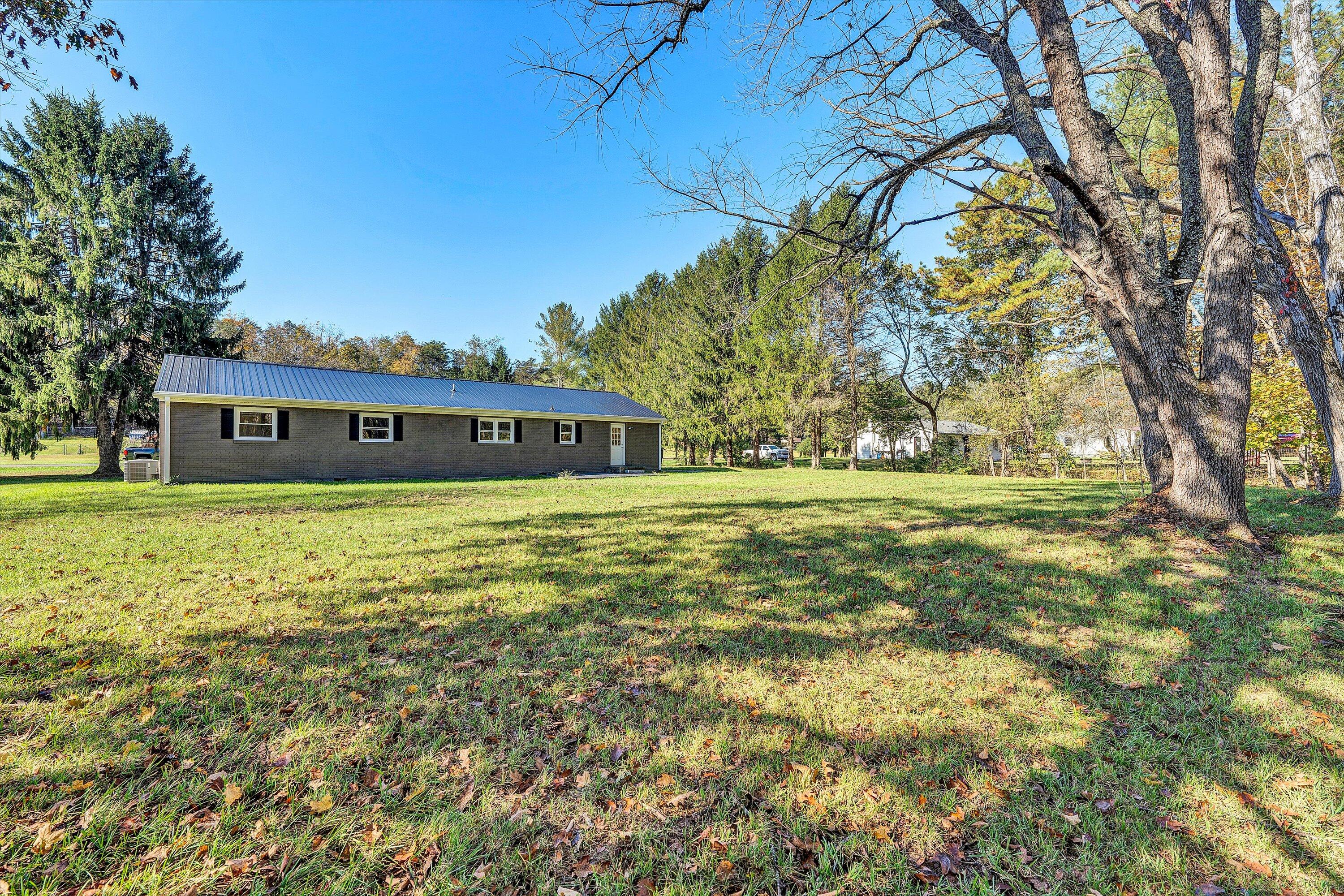 304 Broken Arrow Lane Covington, VA 24426 - Photo 42 of 46 a large pool that has lawn chairs under an umbrella
