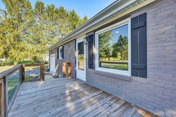 a front view of a house with a yard and wooden floor