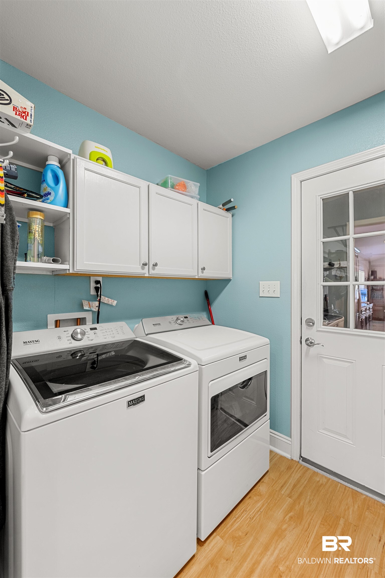 1850 Arcadia Drive Foley, AL 36535 - Photo 30 of 44 Clothes washing area with light wood finished floors, cabinet space, a textured ceiling, independent washer and dryer, and baseboards