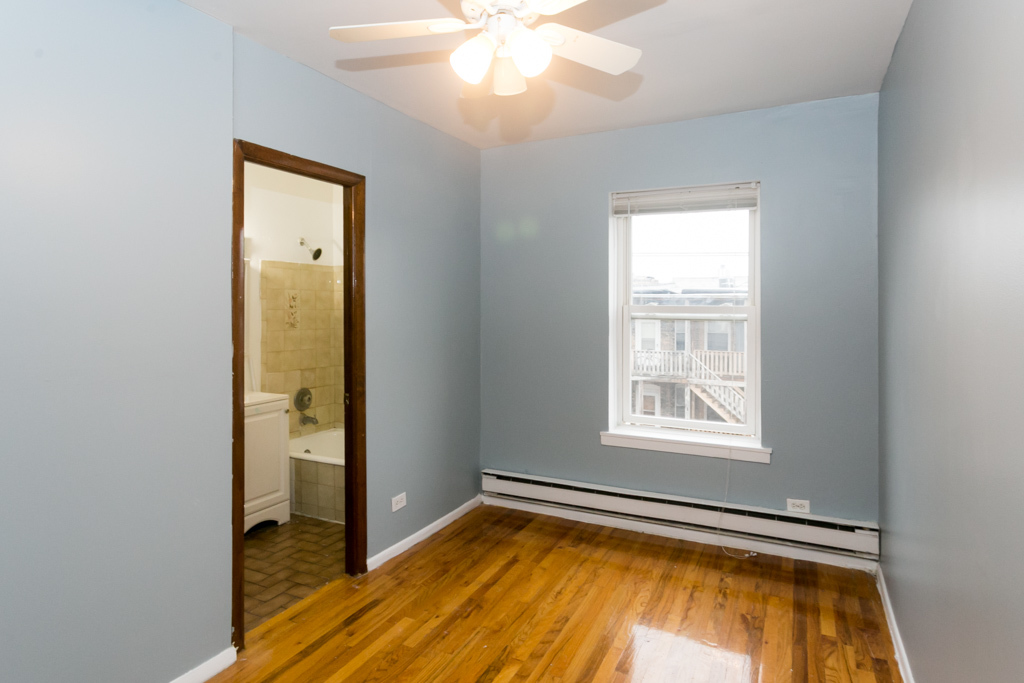 4515 North Malden Street, Unit 3C Chicago, IL 60640 - Photo 14 of 18 an empty room with window and wooden floor