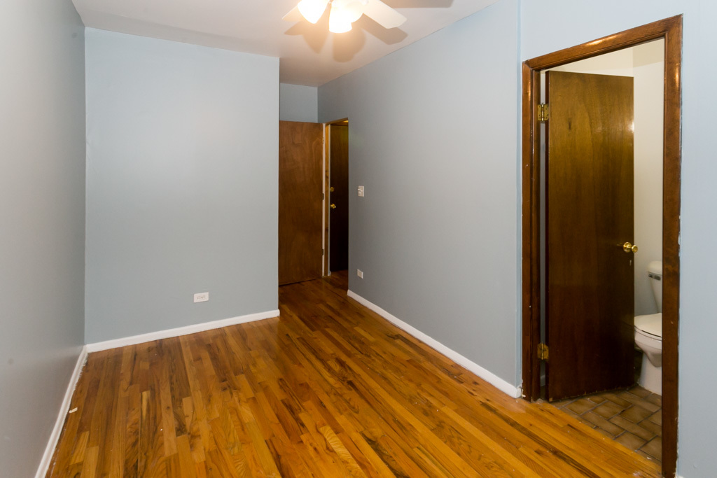 4515 North Malden Street, Unit 3C Chicago, IL 60640 - Photo 15 of 18 a view of an empty room with wooden floor and a bathroom