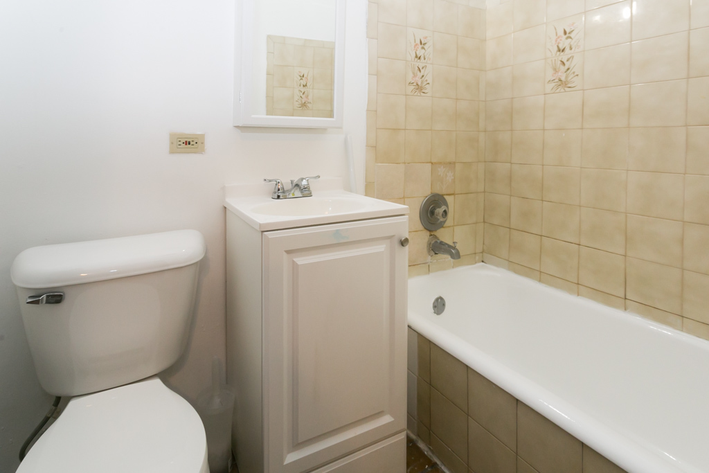 4515 North Malden Street, Unit 3C Chicago, IL 60640 - Photo 18 of 18 a bathroom with a sink a toilet and shower