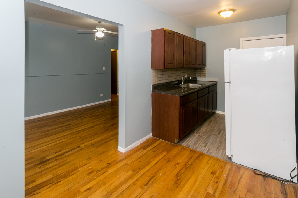 4515 North Malden Street, Unit 3C Chicago, IL 60640 - Photo 4 of 18 a view of kitchen with refrigerator and wooden floor