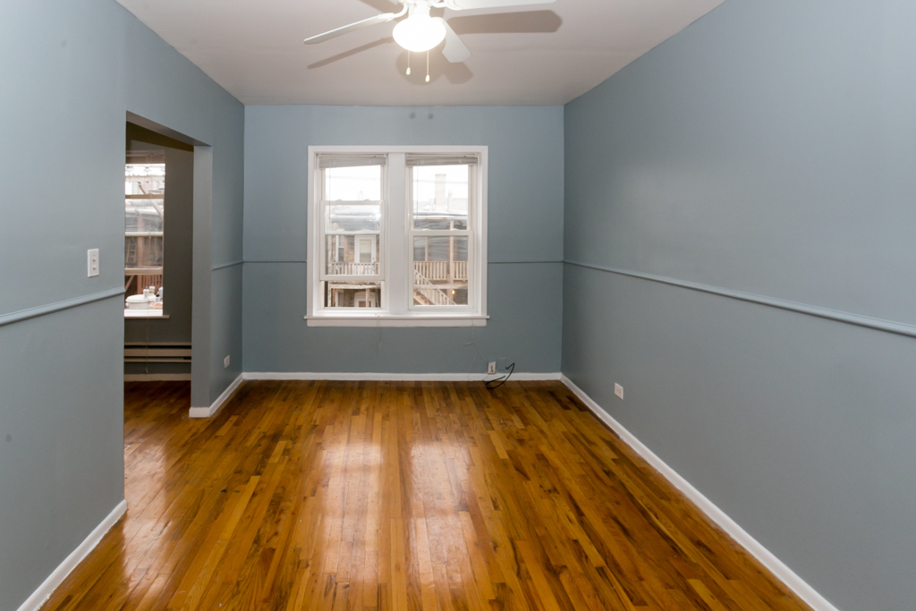 4515 North Malden Street, Unit 3C Chicago, IL 60640 - Photo 7 of 18 wooden floor in an empty room with a window