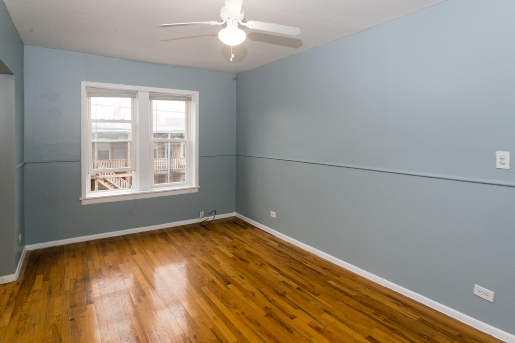 4515 North Malden Street, Unit 3C Chicago, IL 60640 - Photo 8 of 18 wooden floor in an empty room with a window