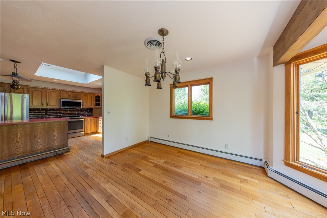 7969 Dines Road Novelty, OH 44072 - Photo 13 of 48 Dining area featuring hardwood flooring, a traditional chandelier, recessed lighting, and multiple windows with wood frames