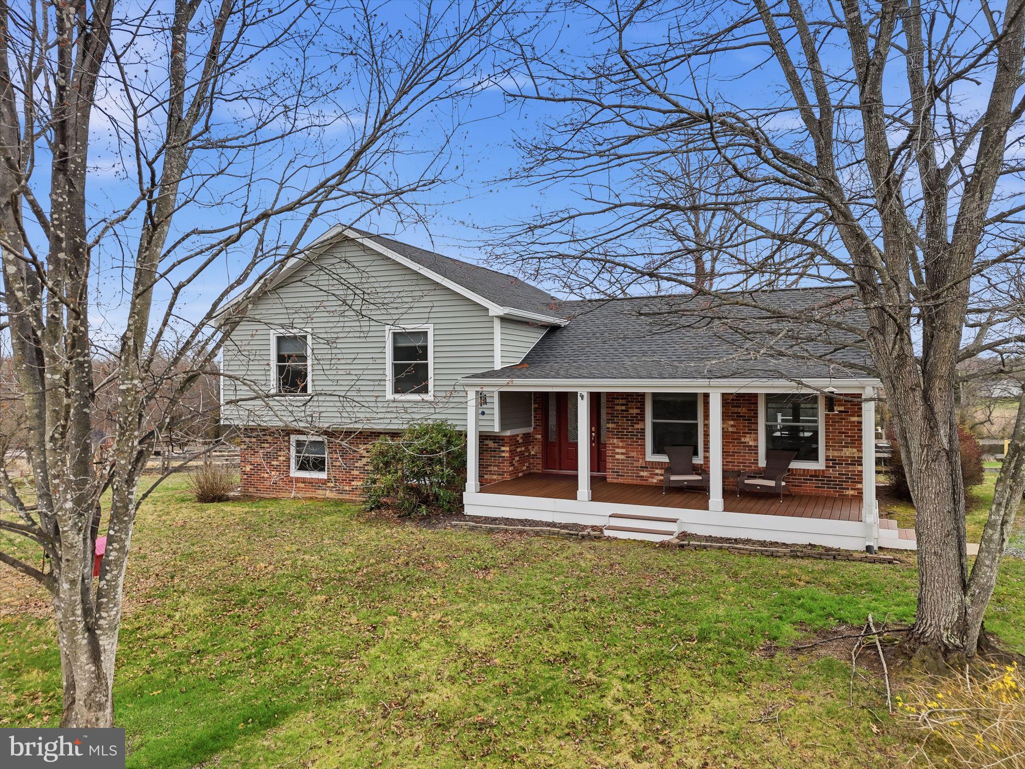 a front view of a house with yard and green space