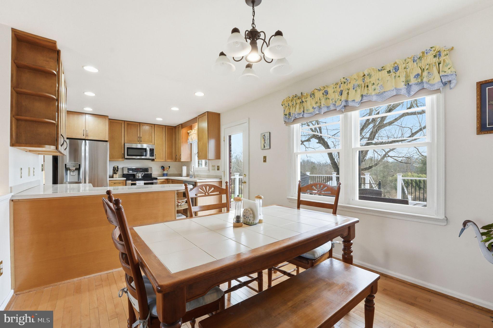 4051 Ringwood Road Nokesville, VA 20181 - Photo 15 of 58 a view of a dining room with furniture a chandelier and wooden floor