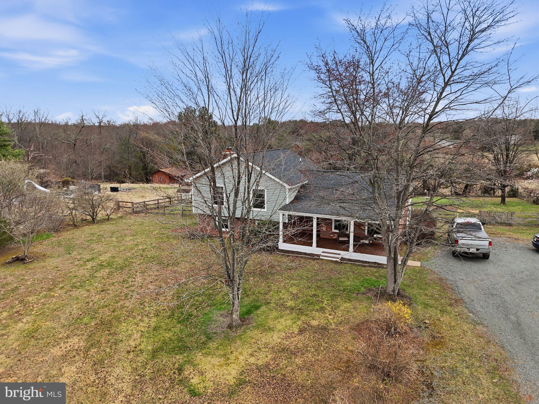 4051 Ringwood Road Nokesville, VA 20181 - Photo 4 of 58 a view of a house with a yard covered in the forest
