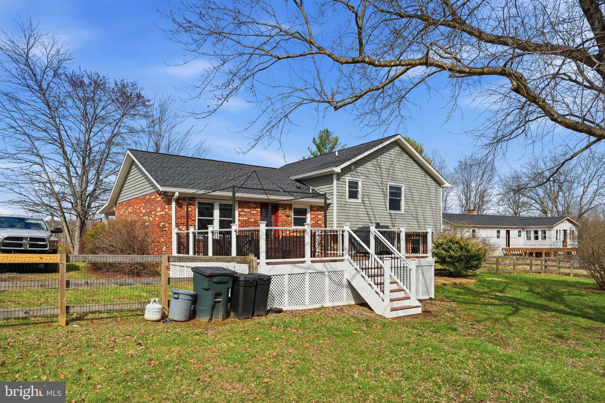 4051 Ringwood Road Nokesville, VA 20181 - Photo 47 of 58 a view of a house with a yard deck and a large tree