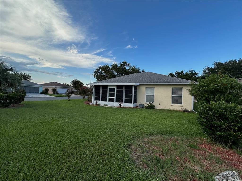 9706 Southwest 92nd Place Road Ocala, FL 34481 - Photo 35 of 82 a view of a yard in front of a house with a large tree