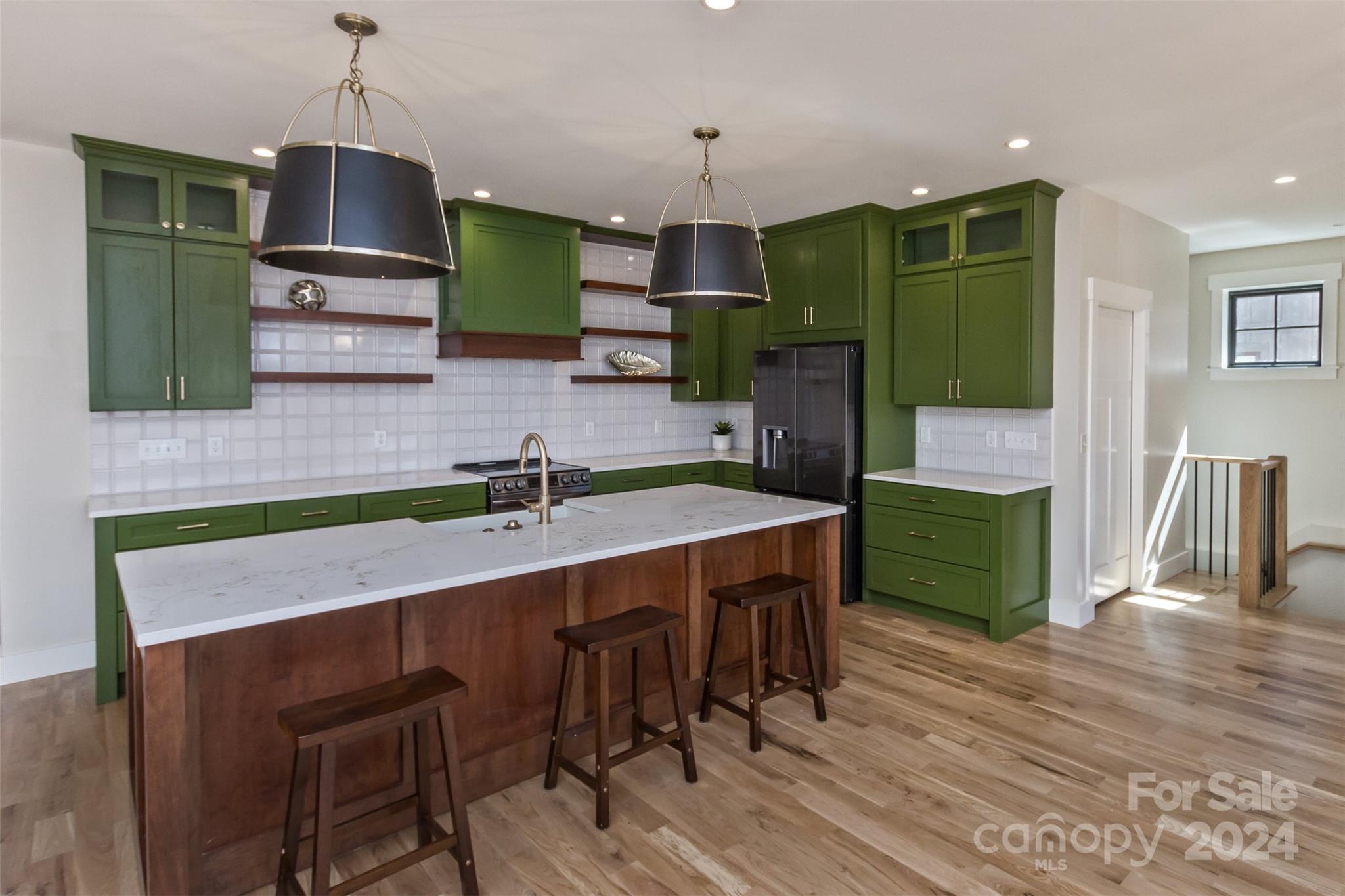 157 Gashes Creek Road Asheville, NC 28805 - Photo 12 of 43 a kitchen with a table chairs refrigerator and microwave
