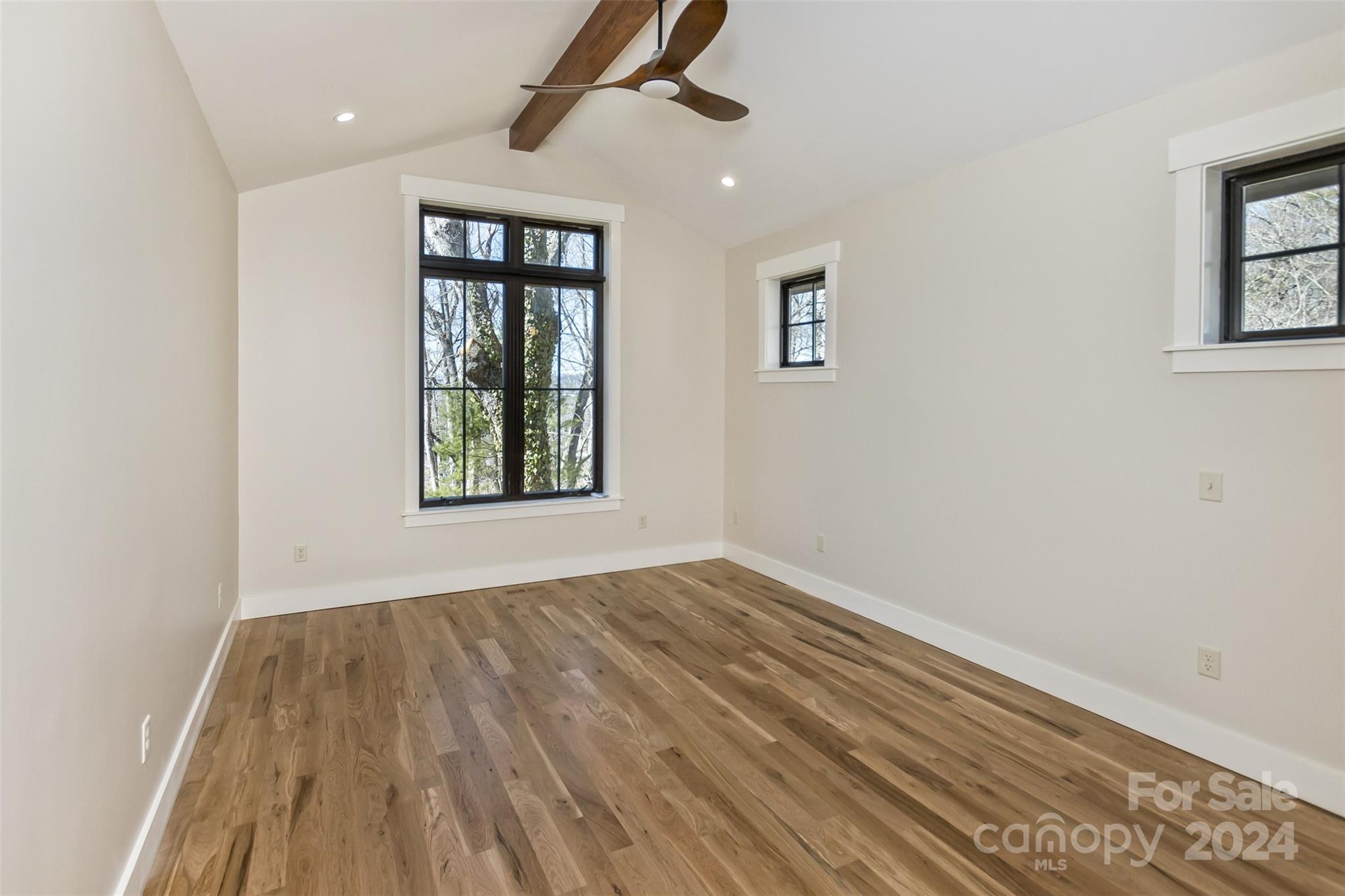 157 Gashes Creek Road Asheville, NC 28805 - Photo 16 of 43 a view of an empty room with wooden floor and a window
