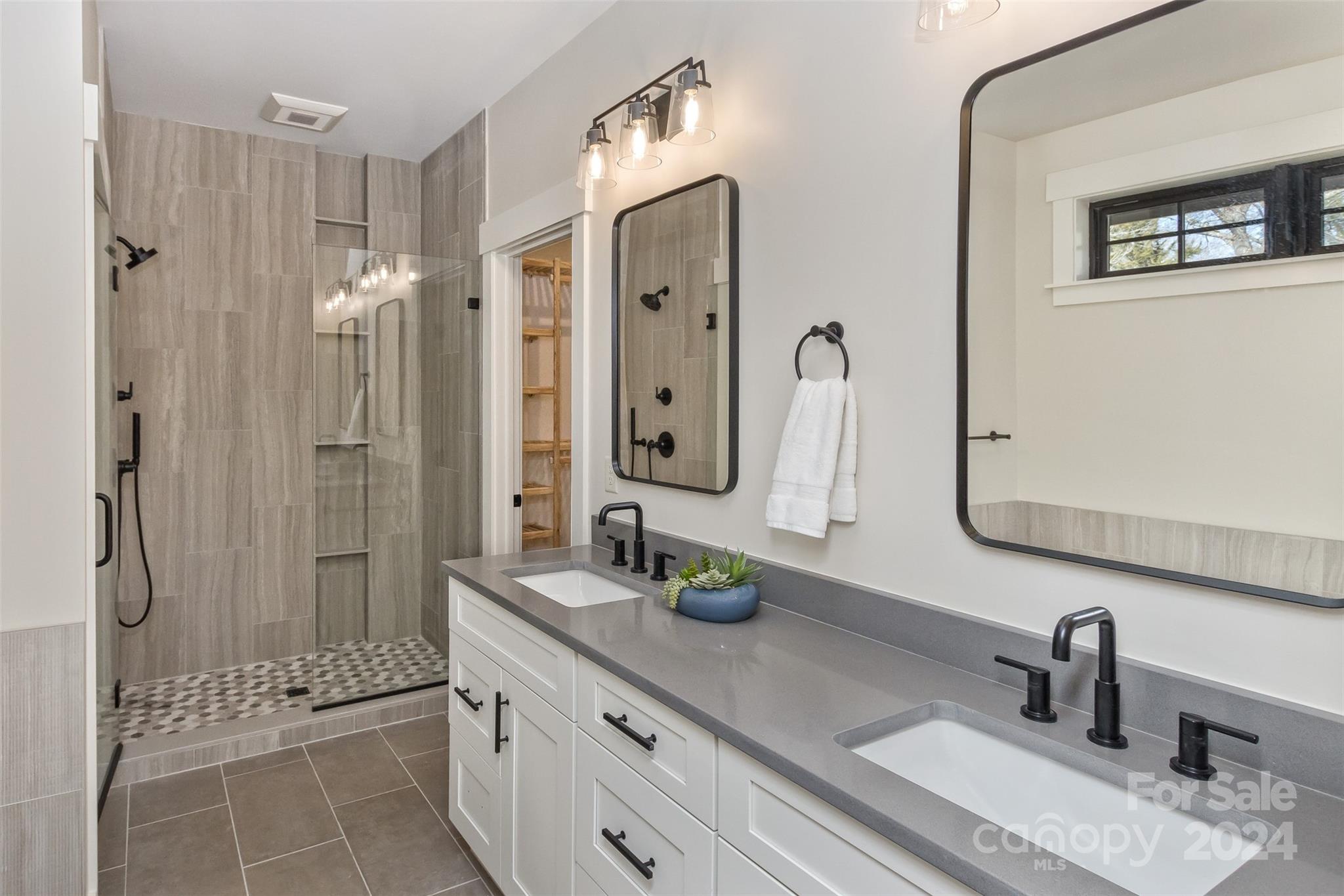 157 Gashes Creek Road Asheville, NC 28805 - Photo 18 of 43 a bathroom with a double vanity sink mirror and shower