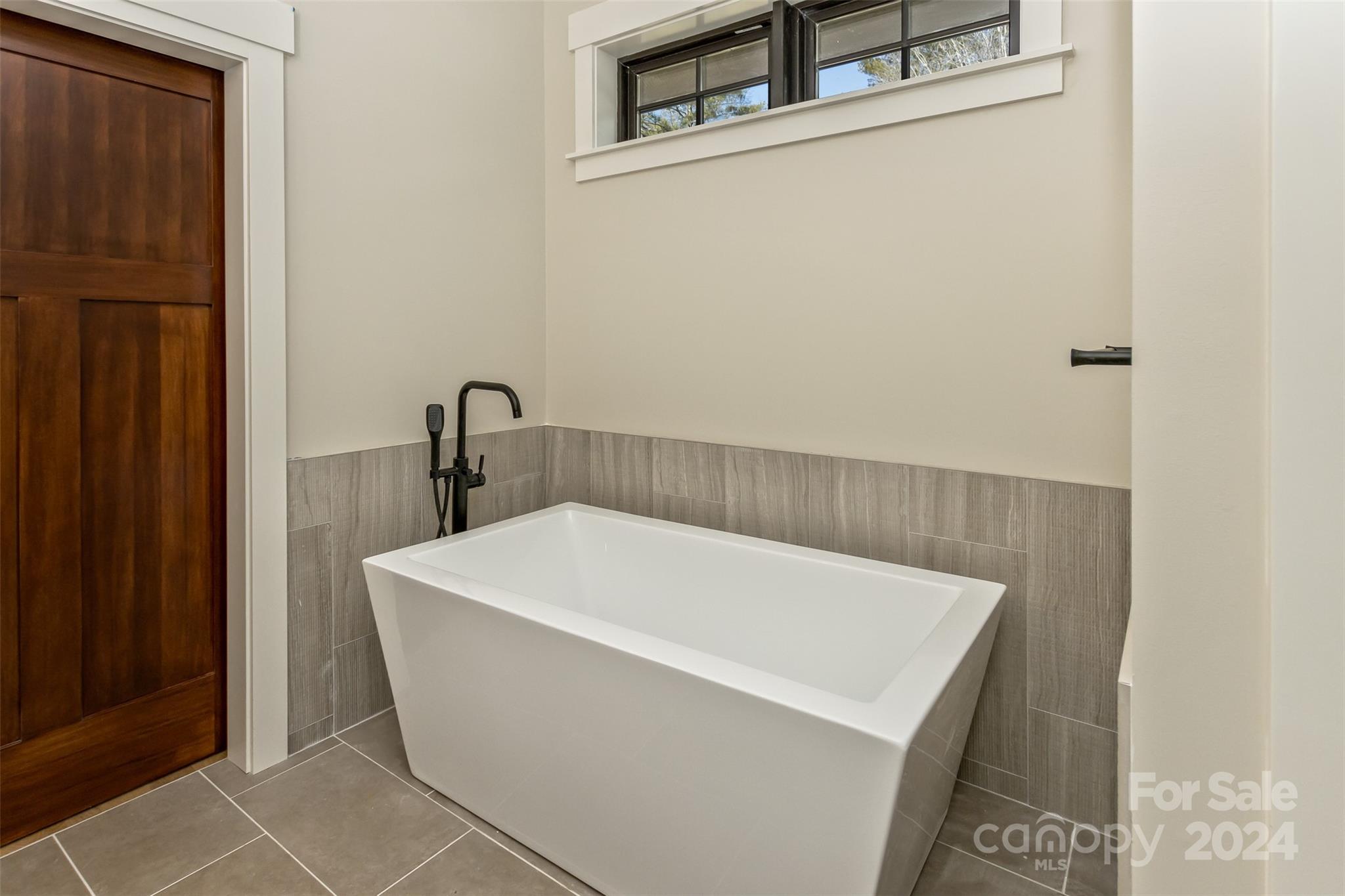 157 Gashes Creek Road Asheville, NC 28805 - Photo 20 of 43 a white bath tub sitting in a bathroom