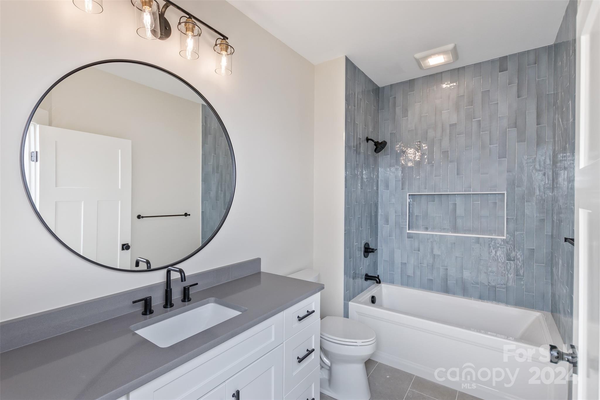 157 Gashes Creek Road Asheville, NC 28805 - Photo 25 of 43 a bathroom with a sink a toilet and a mirror