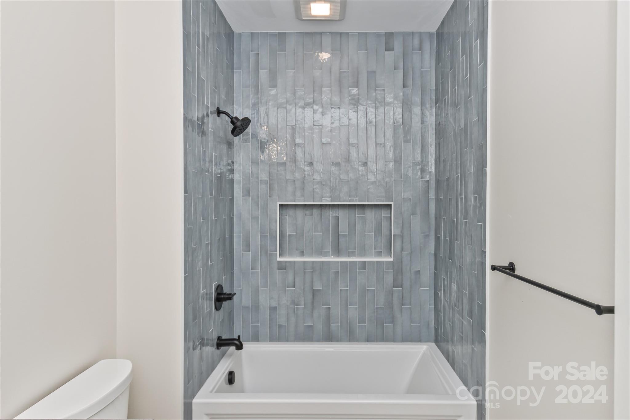 157 Gashes Creek Road Asheville, NC 28805 - Photo 27 of 43 a bathroom with a tub shower and toilet