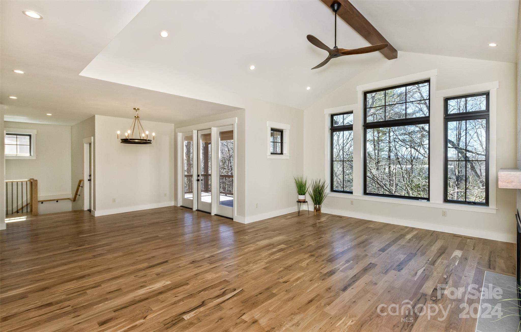 157 Gashes Creek Road Asheville, NC 28805 - Photo 6 of 43 a view of an empty room with wooden floor and a window