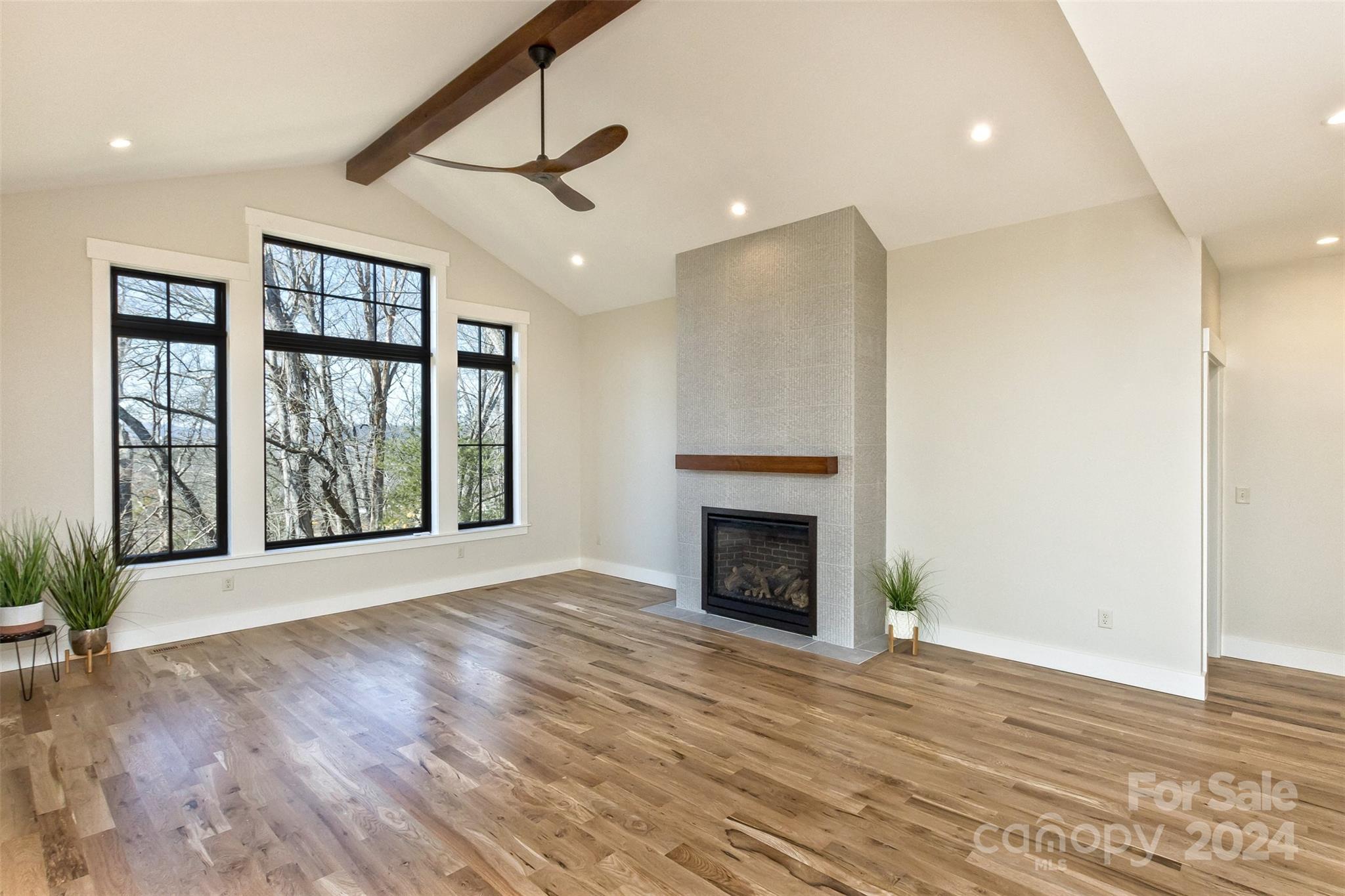 157 Gashes Creek Road Asheville, NC 28805 - Photo 7 of 43 an empty room with floor to ceiling windows and fireplace