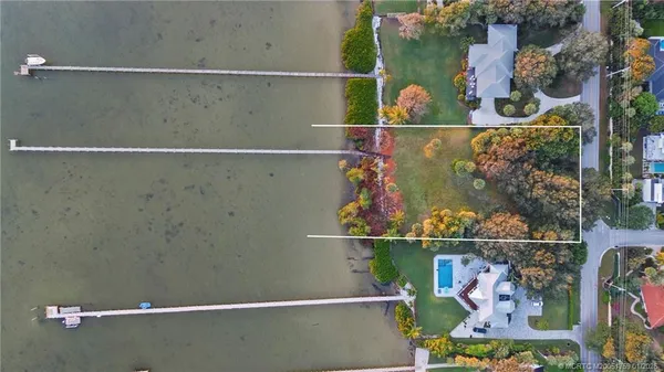 an aerial view of a residential houses with city view