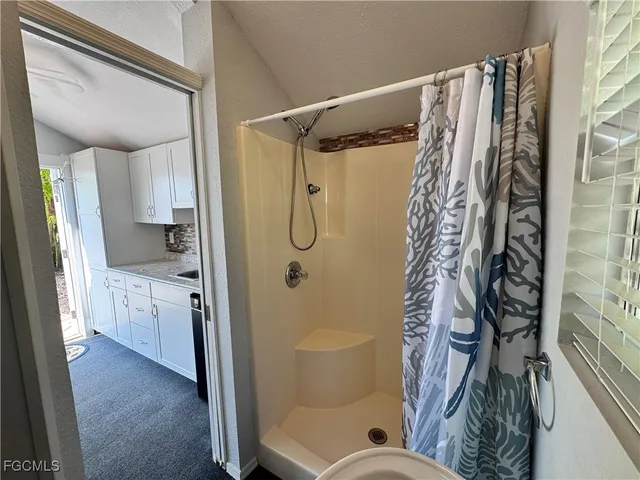 a bathroom with a shower curtain and a sink