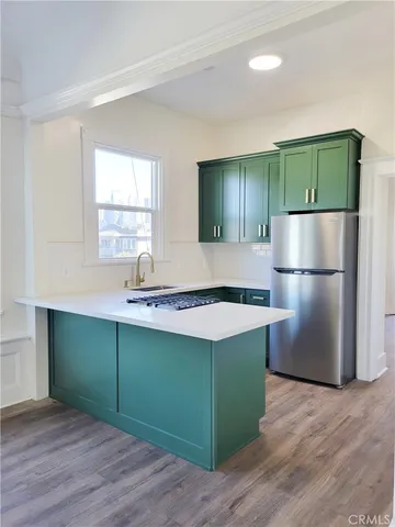 a kitchen with a refrigerator and a sink