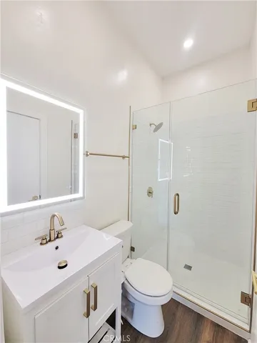 a bathroom with a sink toilet and shower