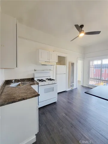 a kitchen with a stove a sink and a refrigerator