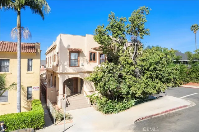 a front view of a house with a yard and fountain