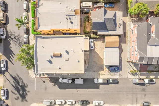 a picture of a building with a couple of cars parked in front of it