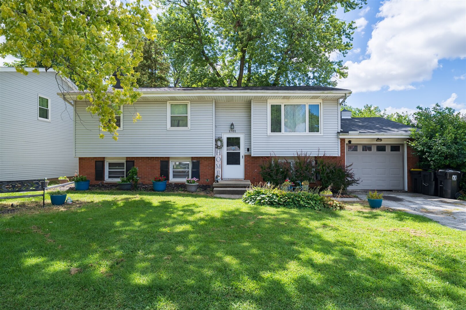 a house view with a sitting space and garden