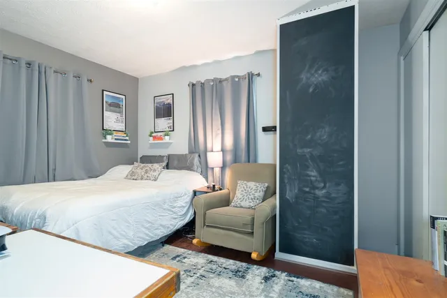 a bedroom with a bed couch and a window