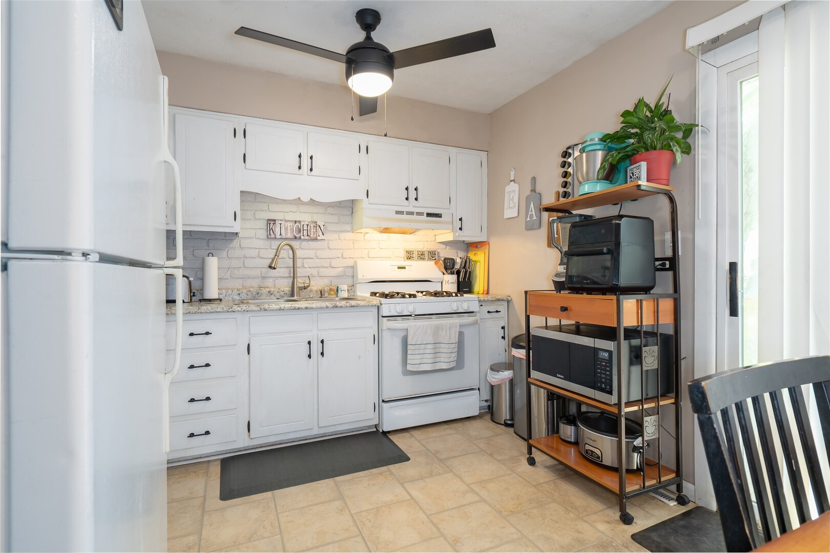 1701 Hoover Drive Normal, IL 61761 - Photo 9 of 30 a kitchen with white cabinets and white appliances