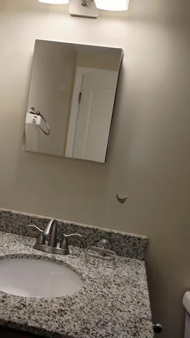 a bathroom with a sink and mirror