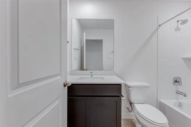 a bathroom with a sink toilet and mirror