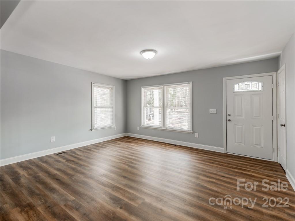 1629 Wadell Stinson Road Lancaster, SC 29720 - Photo 5 of 23 a view of an empty room with wooden floor and window