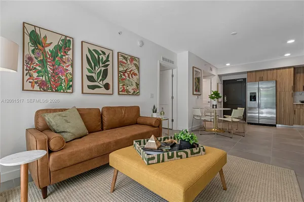 a living room with furniture and painting on the wall