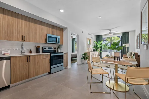 a kitchen with stainless steel appliances a microwave a stove a sink dishwasher and cabinets