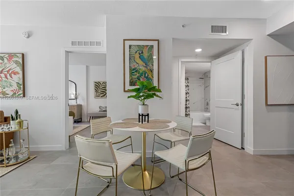 a dining room with furniture and window