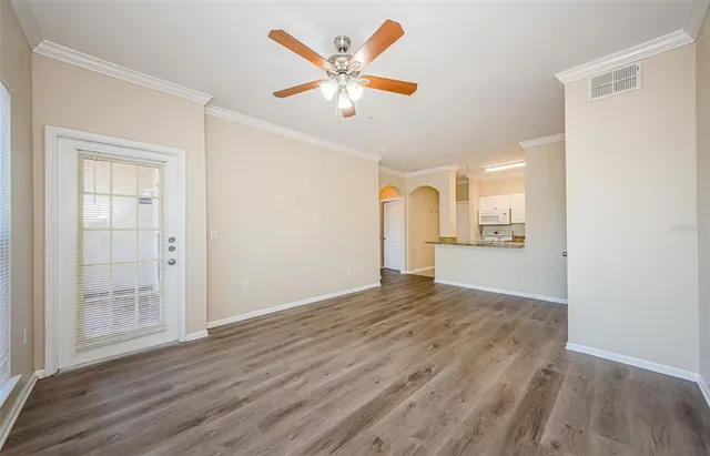 a view of a kitchen with wooden floor and a window