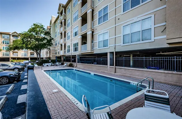 a view of a large building with a swimming pool