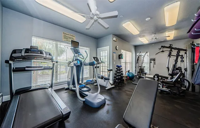 a room with gym equipment and windows