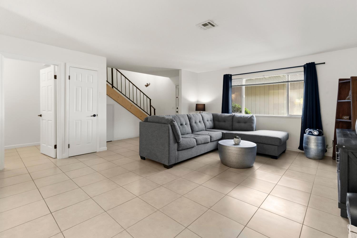 7428 Ranch Avenue Citrus Heights, CA 95610 - Photo 13 of 49 a living room with furniture a flat screen tv and a large window