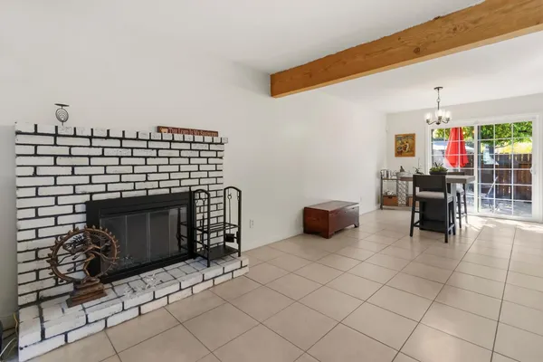 a living room with furniture a fireplace and a table