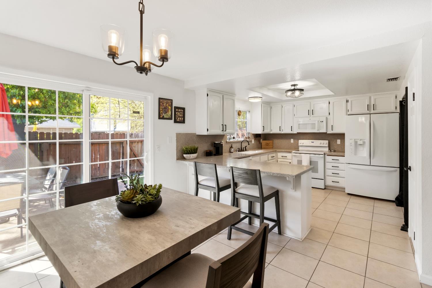 7428 Ranch Avenue Citrus Heights, CA 95610 - Photo 20 of 49 a kitchen with stainless steel appliances granite countertop a stove a refrigerator a sink a dining table and chairs with wooden floor