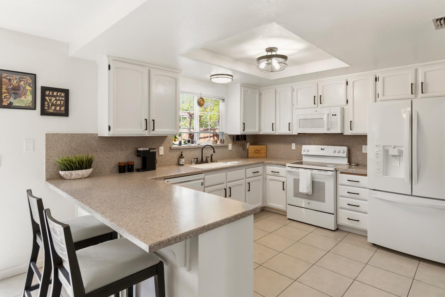 7428 Ranch Avenue Citrus Heights, CA 95610 - Photo 21 of 49 a kitchen with white cabinets and stainless steel appliances