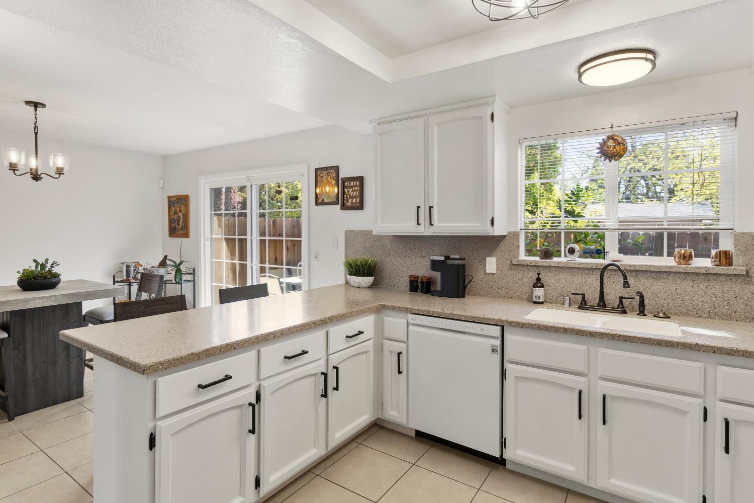 7428 Ranch Avenue Citrus Heights, CA 95610 - Photo 22 of 49 a kitchen with white cabinets and window