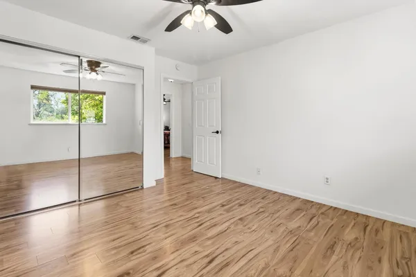 wooden floor in an empty room with a window